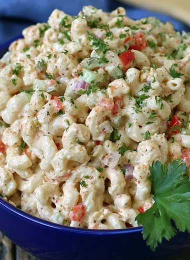 Delicious macaroni salad with vegetables and dressing in a bowl