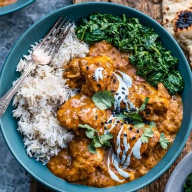 Slow cooker chicken curry served with rice and fresh herbs