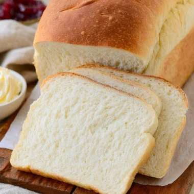 Homemade sourdough discard sandwich bread loaf on a wooden cutting board
