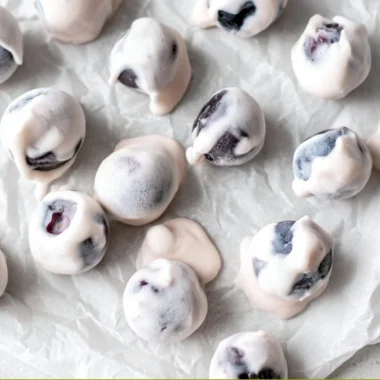 Bowl of yogurt covered blueberries, a healthy and sweet snack option.