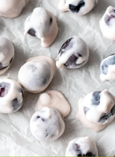 Yogurt covered blueberries in a bowl, a healthy snack option.