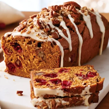 Freshly baked Pumpkin Cranberry Bread on a rustic table