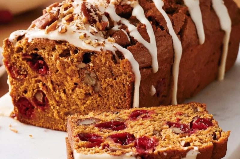 Freshly baked Pumpkin Cranberry Bread on a rustic table